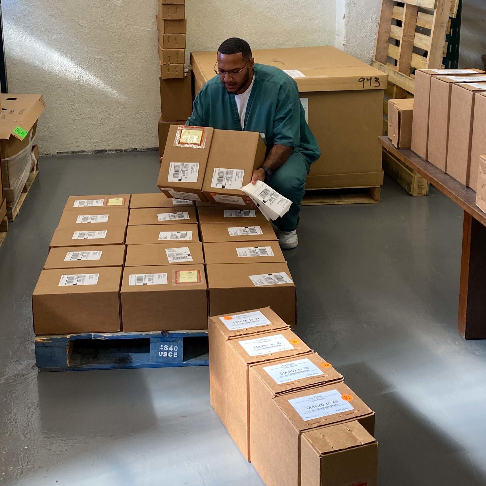 Terry Gaines loading boxes on a pallet for shipping