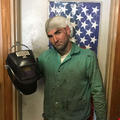 Mr Peters holding a welding helmet
