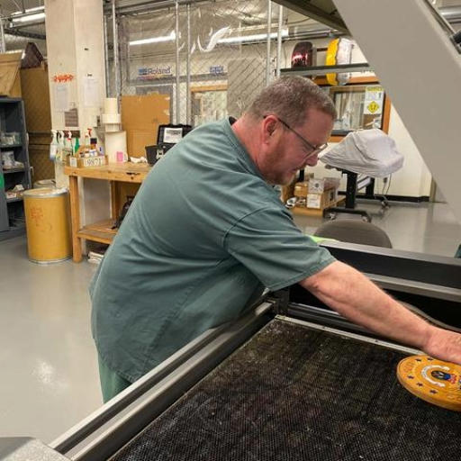 Jefferson Kiser working at laser engraving machine
